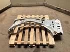 Silver 13-18 RAM 1500 front left driver frame apron radiator support on worn concrete, resting on a wooden pallet.