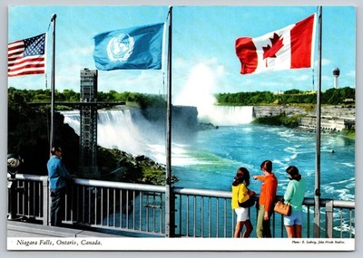 Vintage Niagara Falls Ontario Rainbow Bridge with Flags Postcard
