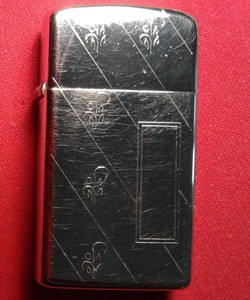 Zippo-Slim-Lighter-with-etched-design-on-front-and-back-of-lighter