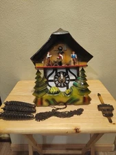 German E. Schmeckenbecher Black Forest cuckoo clock, with a musical sawmill.