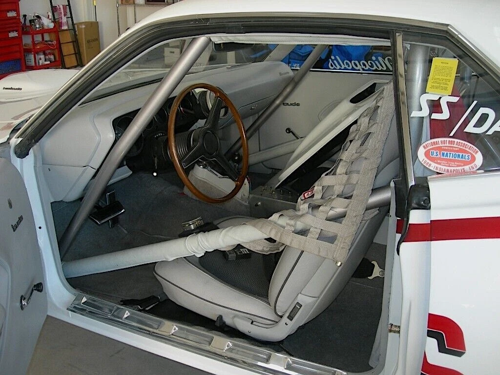 The NHRA racer's interior remains stock, with the addition of the roll bar.
