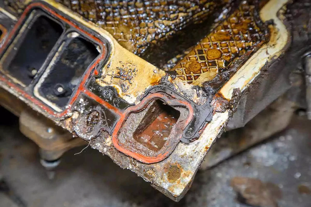 A close-up view of an engine with a melted intake manifold gasket.