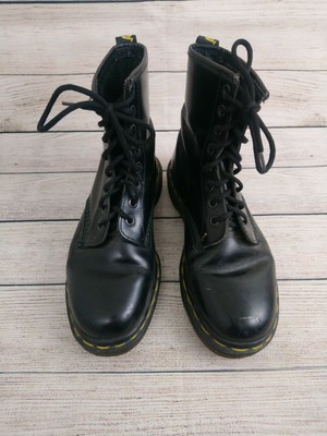 black boots with yellow stitching