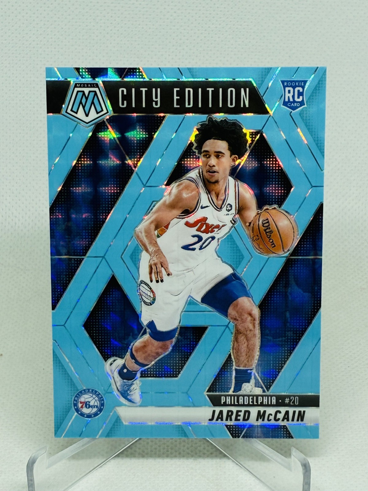 2024-25 Panini Mosaic Jared McCain City Edition Blue Fluorescent Mosaic 52/75 RC