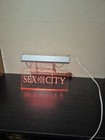 Neon Lights Up Sex And The City Sign (E9)