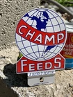 New ListingVINTAGE "CHAMP FEEDS" METAL LICENSE PLATE TAG TOPPER, (5"x 3.5") GOOD COND