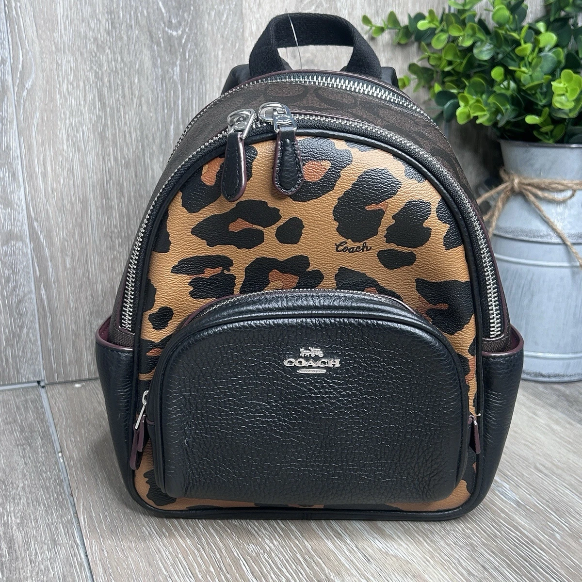 cheetah print coach backpack Mini Court In Signature Canvas With Leopard Signature coated canvas printed coated canvas and refined pebble leather Inside zip and multifunction pockets Double zip closure fabric lining Handle with 1 1/2 drop Outside zip and open pockets Adjustable shoulder straps 7 3/4 (L) x 8 3/4 (H) x 3 1/2 (W) Style No. Jamie Camera Bag With Signature