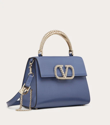 Blue and white Valentino Vsling small bag with gold jewel handle, gold chain strap, and RRP$4,400 USD + tax.