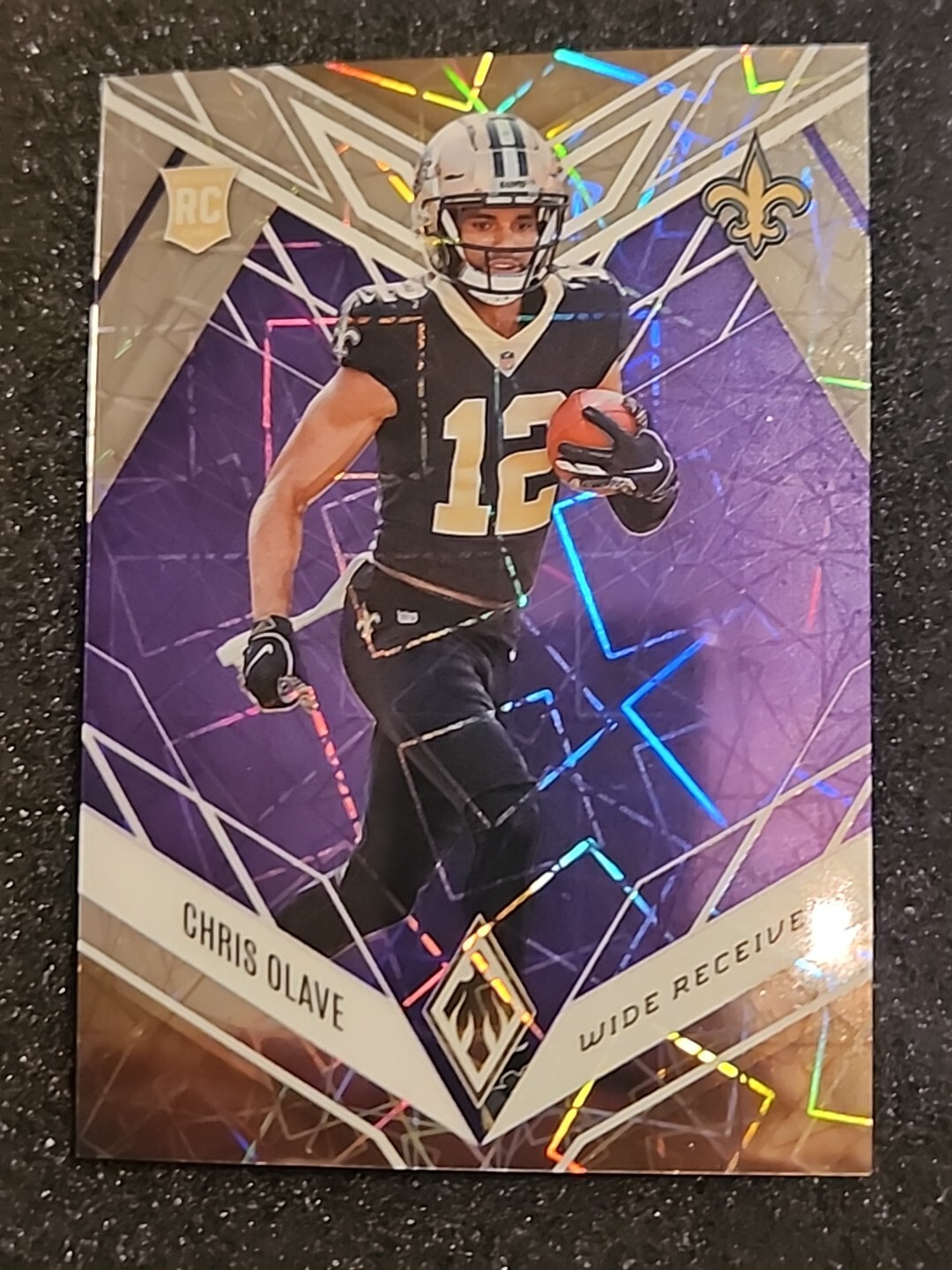 Chris Olave 2022 Phoenix #109 H2 Exclusive Purple Lazer /99 New Orleans Saints