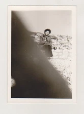 Beautiful Young Woman and a Photographer's Finger Obscuring the Lens Abstract