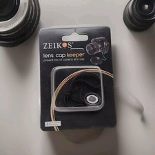 Zeikos Lens Cap Keeper  Brand New  USA Seller    