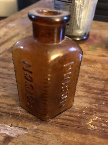 EMBOSSED OVAL AMBER POISON BOTTLE, 100 YEARS OLD 