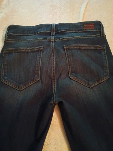 Back view of Paige Jeans Laurel Canyon 27 low rise boot cut medium wash with two pockets and brown leather patch on waistband.