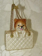 Blown glass ornament. Small dog in the purse.