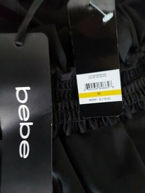 NWT Bebe - Jet Black Satin  Off The Shoulder Ruffled Hem Romper size Medium 