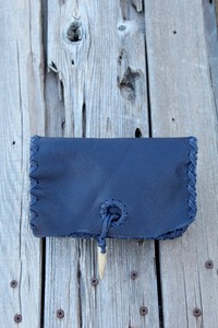 Dark-blue-leather-clutch-phone-bag-with-antler-tip-closure