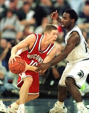 Jon Bryant of Wisconsin tries to dribble around Mateen Cleaves of - Old Photo