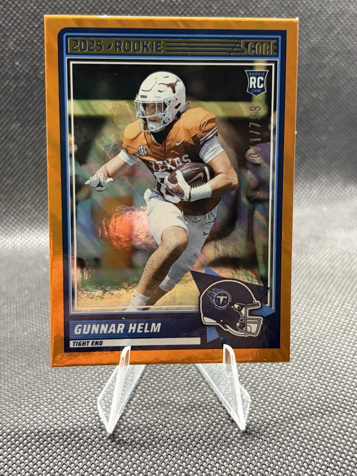 2025 Panini Score- Orange Lava Gunnar Helm RC /799 #99 Tennessee Titans