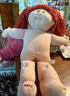 Cabbage patch red hair doll with 15 stamped on rear.