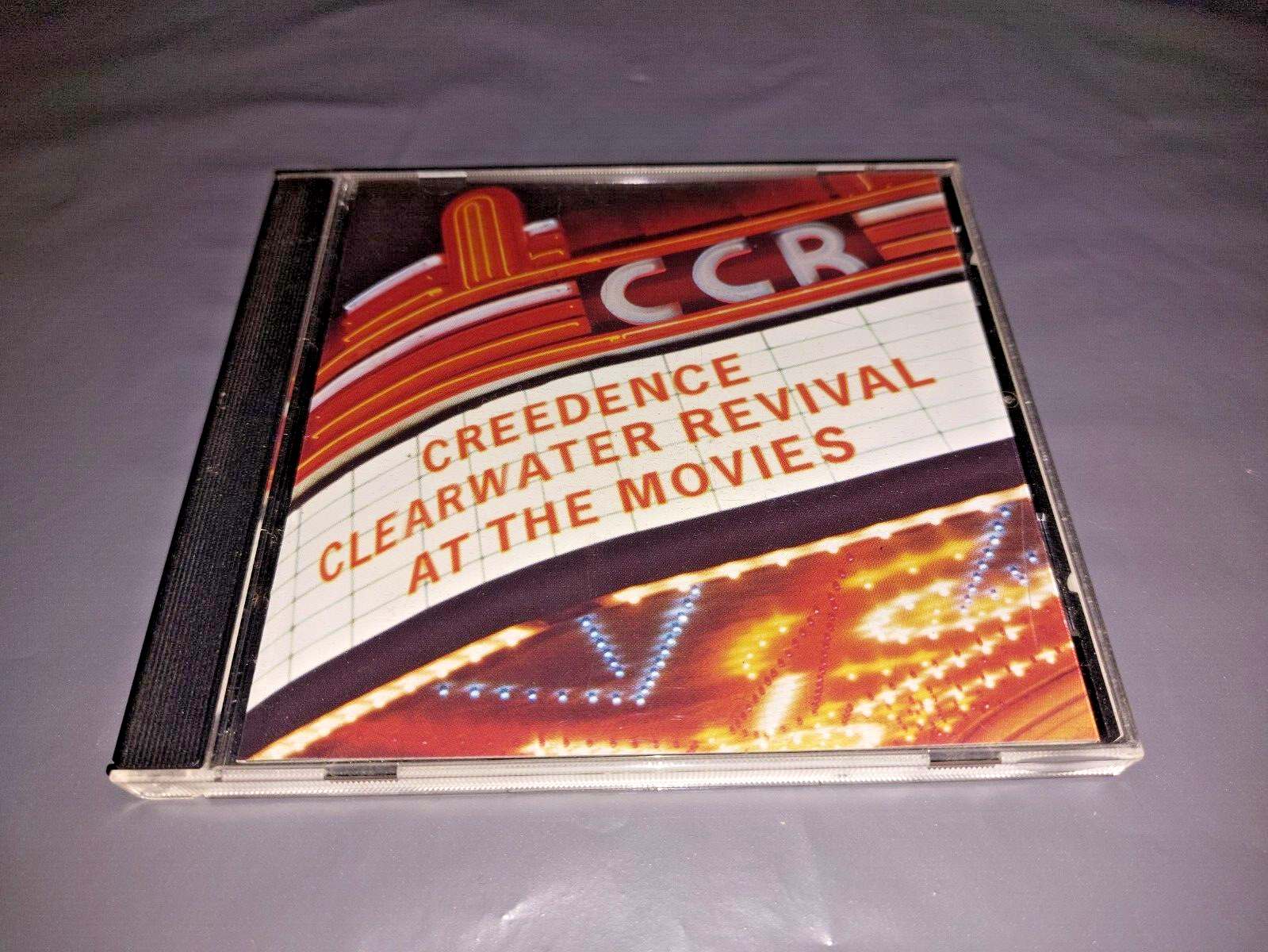 CREEDENCE CLEARWATER REVIVAL * AT THE MOVIES * CD ALBUM EXCELLENT 2000