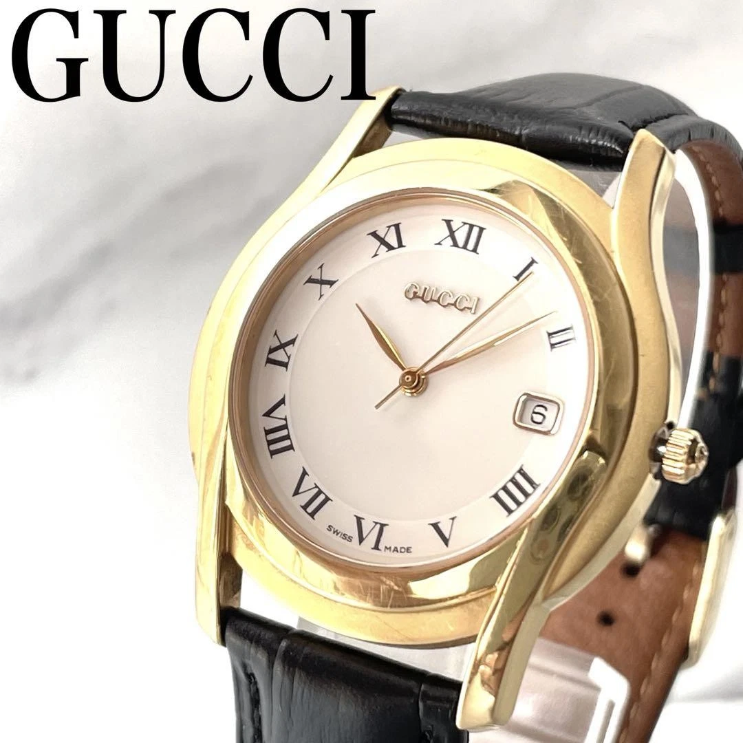 Montre homme Gucci cadran doré, bracelet cuir, mouvement quartz, occasion