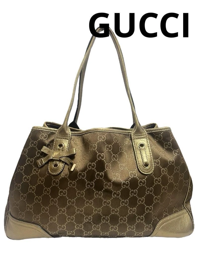 Sac à main Gucci Princy doré sac à bandoulière motif Gg ruban toile fourre tout