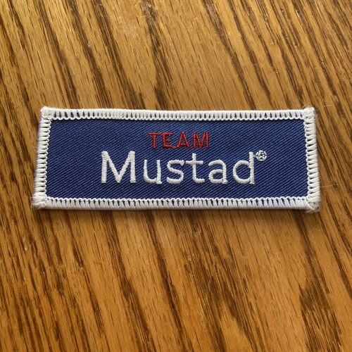 Team Mustad Embroidered Iron On Fishing Patch Company Logo Blue Red - Picture 1 of 2