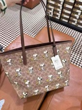 Coach X Peanuts City Tote Bag In Signature Canvas With Snoopy Print CBJ89 2025