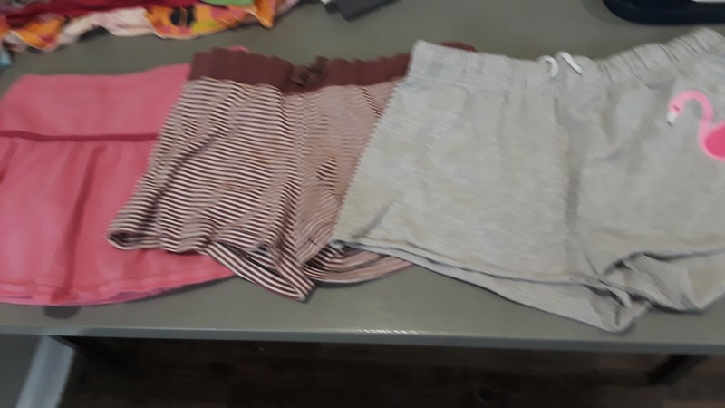 Pink skort, brown and white striped shorts, gray shorts with flamingo