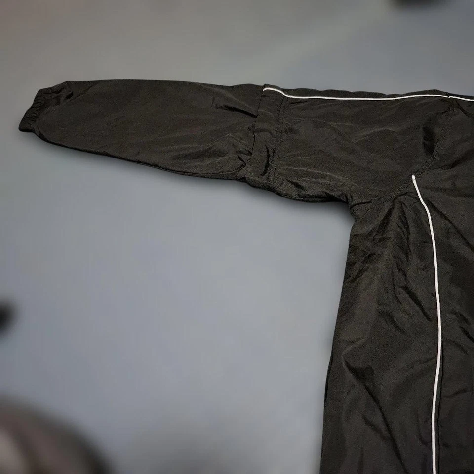 Chaqueta de golf Srixon negra de manga larga con mangas desmontables, líneas laterales blancas Foto 2 de 4