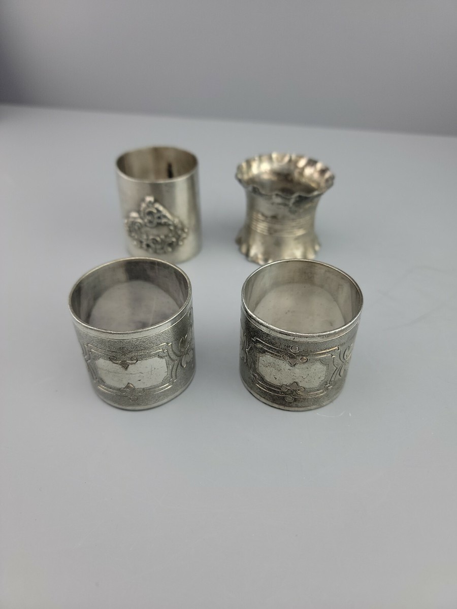 4 vintage napkin rings Not marked as silver.