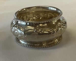 Antique Silver Napkin Ring With Repousse Floral Design And Beaded Edges