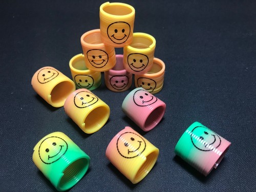 12 pack Slinky Smiley Mini Springs Pinata Party Bag Fillers Wedding Kids Toy - Picture 2 of 2