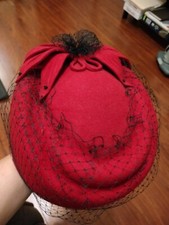 Red pillbox hat with black veil