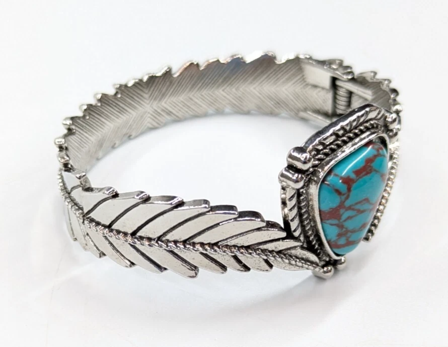 Brazalete grueso tono plata pluma imitación turquesa bisagras Foto 3 de 4