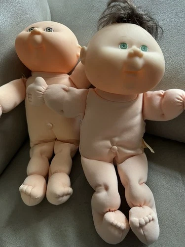 Two vintage Cabbage Patch Kids boy dolls.