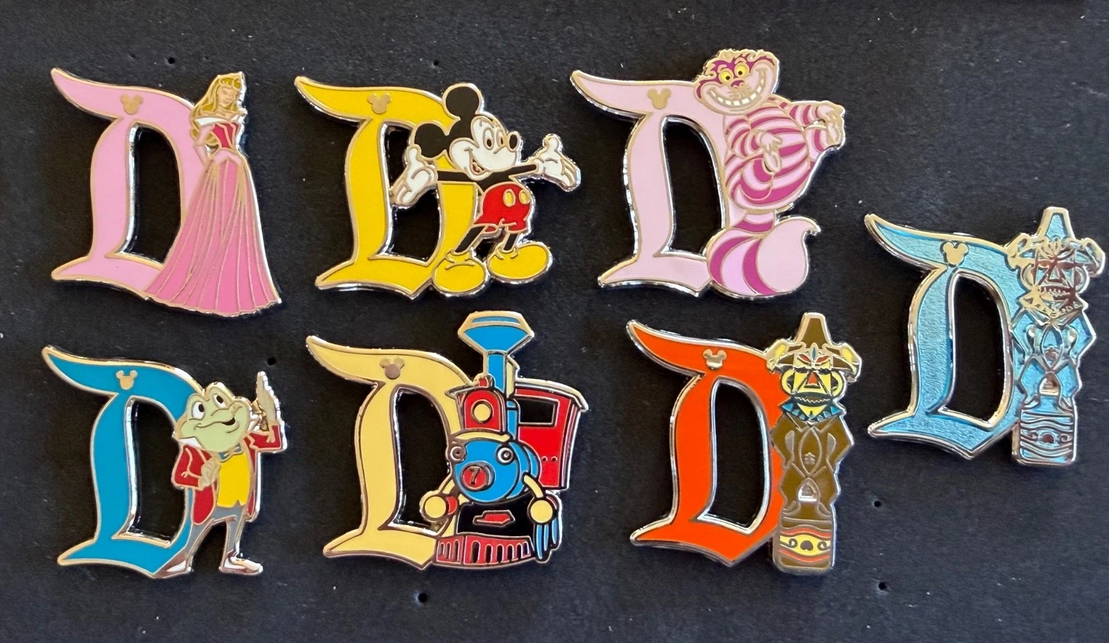 Disneyland Hidden Mickey D set 7 pin 2019 Aurora, Mickey, Cheshire Cat, Mr. Toad