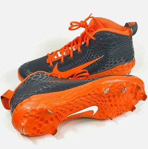 orange and black metal baseball cleats