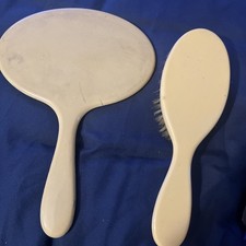 This auction is for Pyralin Celluloid French ivory mirror and brush art deco set