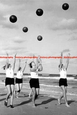 F018682 BDM girls with medicine balls on the beach Unspecified location Around 1