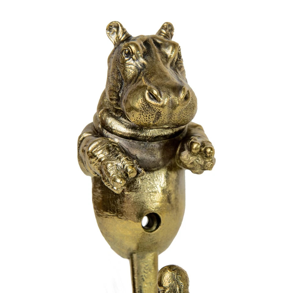 Un gancho de pared para ropa está hecho de latón en forma de hipopótamo. Foto 3 de 4