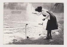 Beautiful Young Woman Feeding Swan on the Lakeside in a Serene Moment Photo