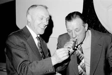 Former Liverpool manager Bill Shankly lights a cigar for his succes- Old Photo