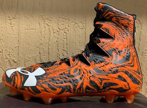 orange and black under armour football cleats