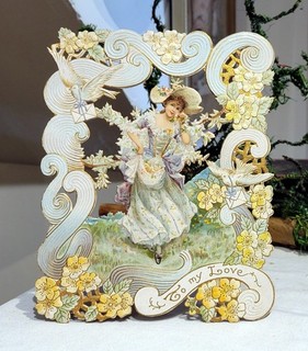 Art Nouveau Lady stepping to Yellow Flowers. Easel backed Valentine. 1900s