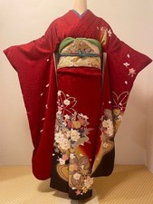 Red silk kimono with cherry blossom and floral motifs, traditional pattern