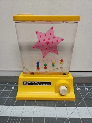 DE COLECCIÓN 1976 TOMY ANILLO STARBALL PLÁSTICO AGUA LANZAMIENTO JUEGO PORTÁTIL JUGUETE Foto 1 de 4