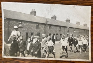 SCHOOL CHILDREN MARCHING ALONG UNIDENTIFIED STREET c1930 Real Photo Post Card - Picture 1 of 2