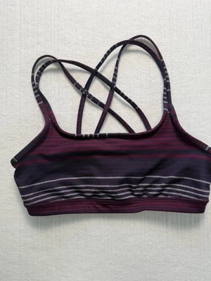 Sujetador deportivo con tiras Athleta púrpura y rosa a rayas entrecruzadas espalda talla mediana Foto 1 de 4