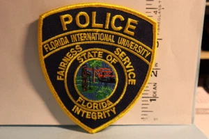 police patch  INTERNATIONAL UNIVESITY POLICE FLORIDA YELLOW BORDERS - Picture 1 of 1